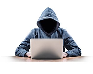 Suspicious person sitting in front of a laptop
