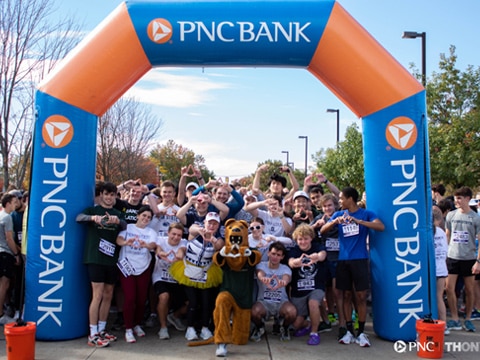 Runners, Penn State students, and a panther at the THON 5K