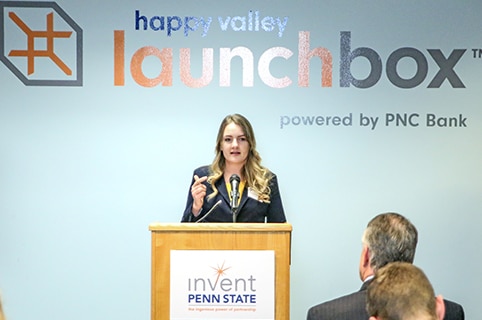 McCulloch speaking in front of a Happy Valley LaunchBox Powered by PNC sign