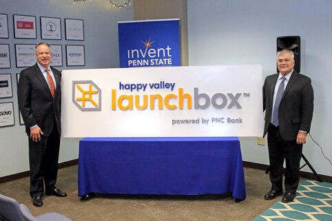 jim hoehn and eric barron with the new launchbox powered by pnc sign