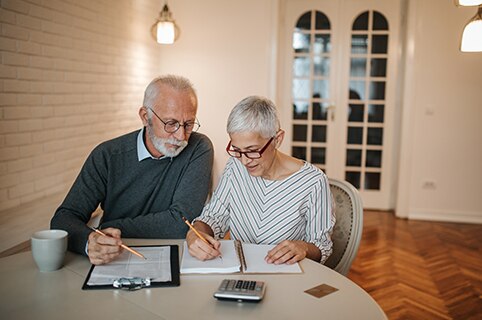 older couple reviewing financial statements