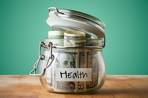 jar labeled 'health' with money in it