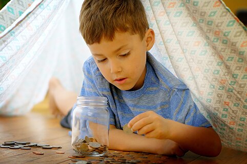 Kid in fort counting coins