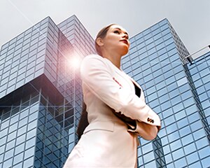businesswoman standing in front of tall building