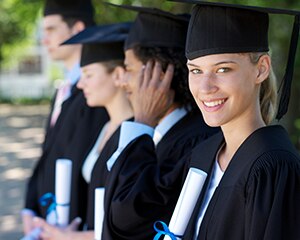 students smiling in caps and gowns