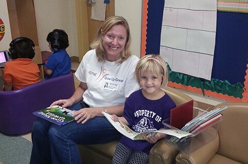 Nichole Vaughan reading with child