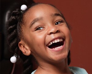 Young girl expressing happiness by smiling