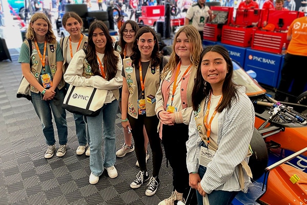 A group of girls visiting behind the scenes of an INDYCAR race