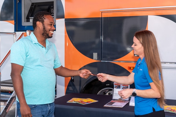 People interacting in front of Mobile Branch