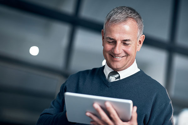 Man in casual business attire on a tablet