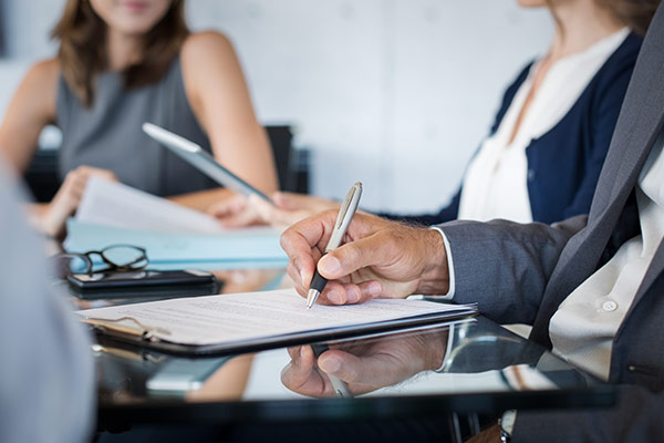 conference desktop with multiple people making notes.