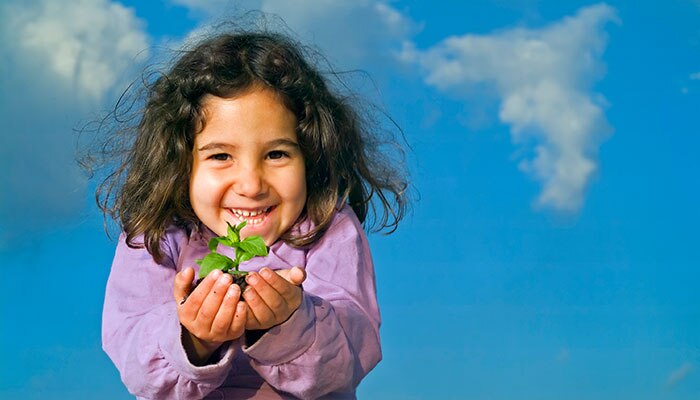 child holding a sprouted seed