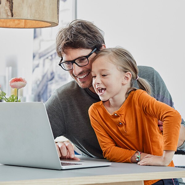 Father and daughter using computer together